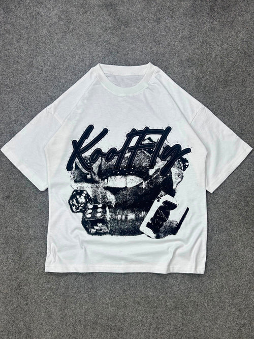 A white short-sleeve t-shirt with a black graphic print featuring the text 'Kool Fly' and a women's mouth design, laid flat on a gray textured background.